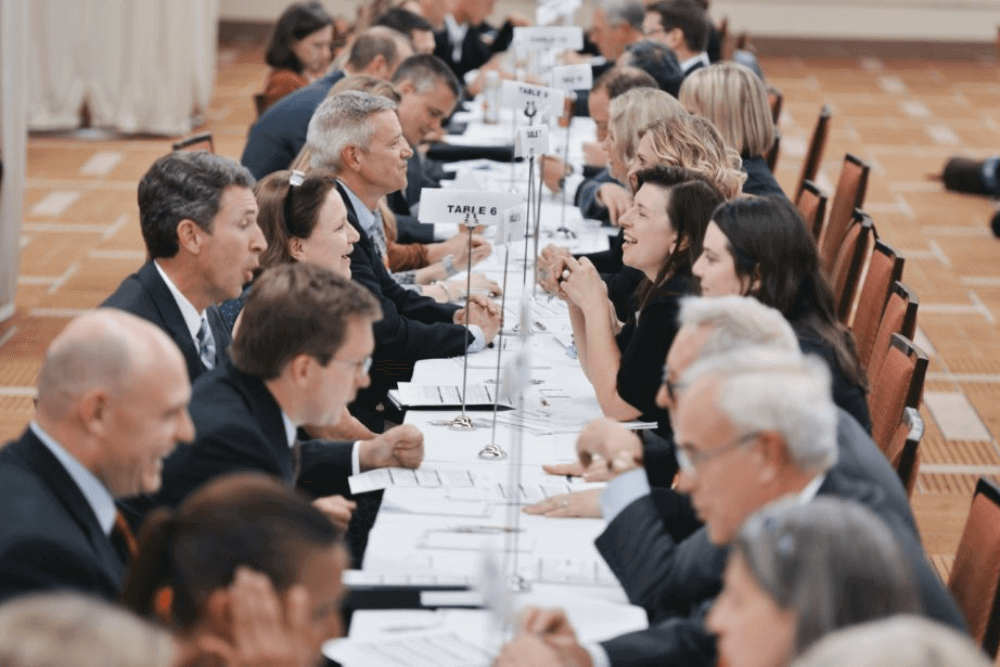 A long table with participants of a speed networking event
