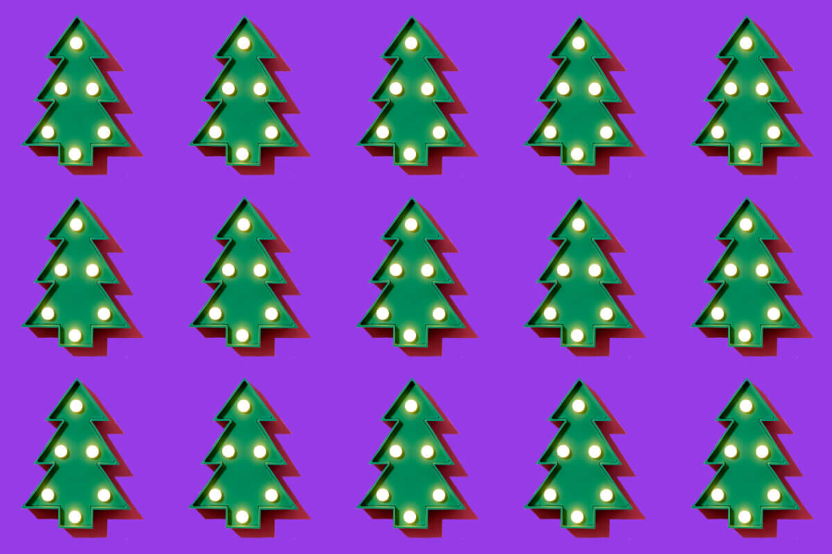 a header image for slido's christmas themed blog depicting 15 christmas trees on a solid purple background