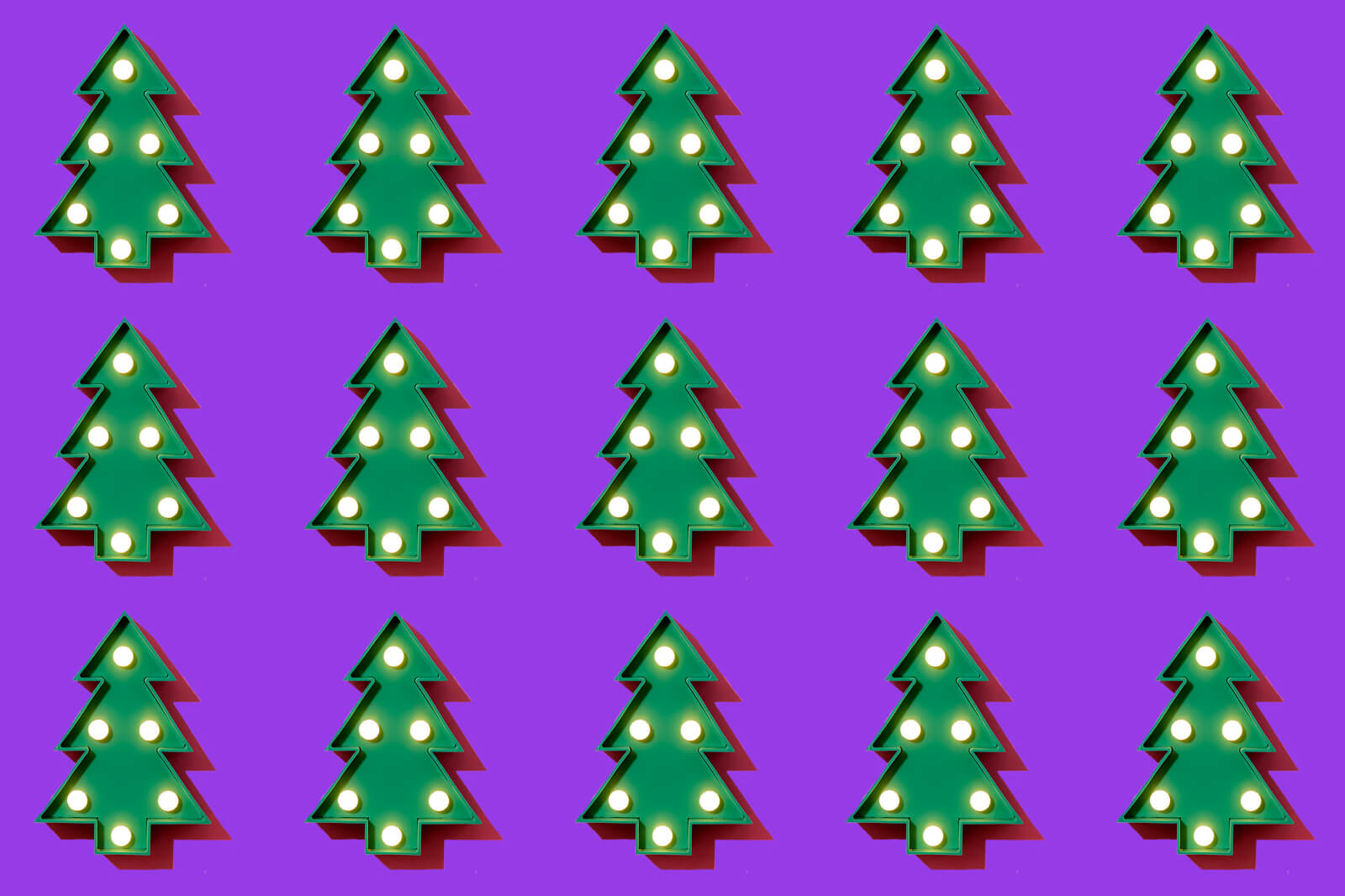 a header image for slido's christmas themed blog depicting 15 christmas trees on a solid purple background