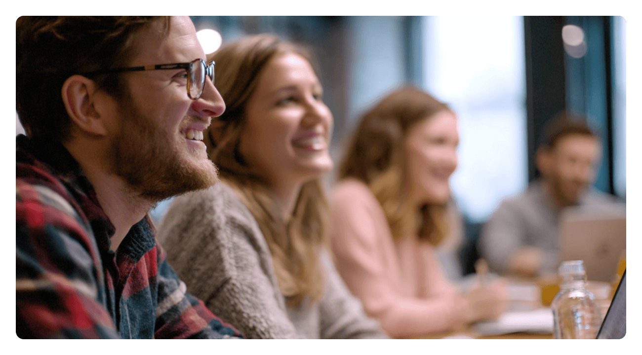 A team in a kick off meeting looking happy and ready to discuss how they will tackle the upcoming year