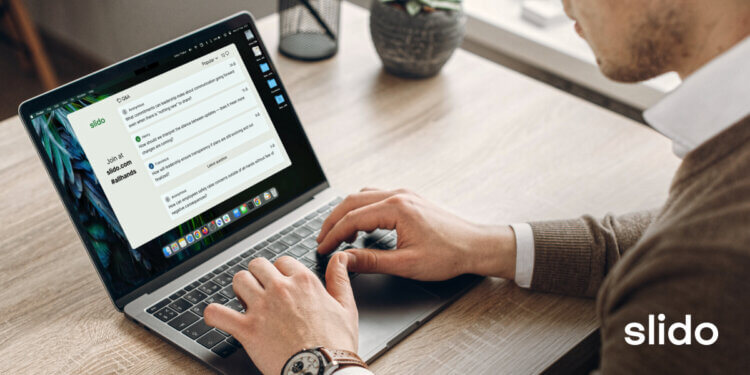 Man at laptop looking at Slido questions